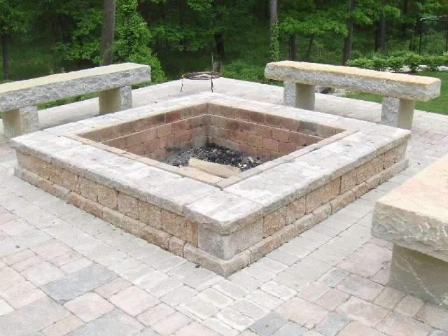 Stone fire pit with paver patio seating